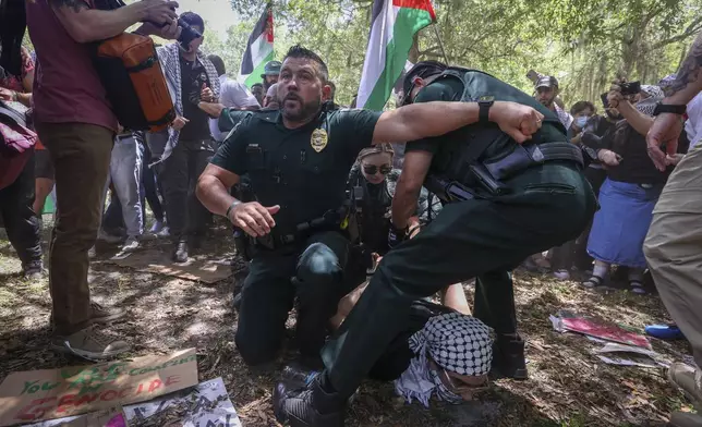 University of South Florida police officers take pro Palestinian protesters into custody during a march on the campus Monday, April 29, 2024 in Tampa. (Chris Urso/Tampa Bay Times via AP)