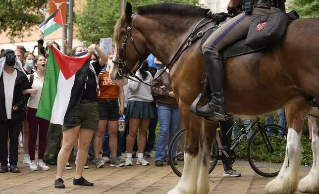 Cally, a former UT student, faces off with a mounted state trooper at a pro-Palestinian protest at the University of Texas, Wednesday, April 24, 2024, in Austin. (Jay Janner/Austin American-Statesman via AP)