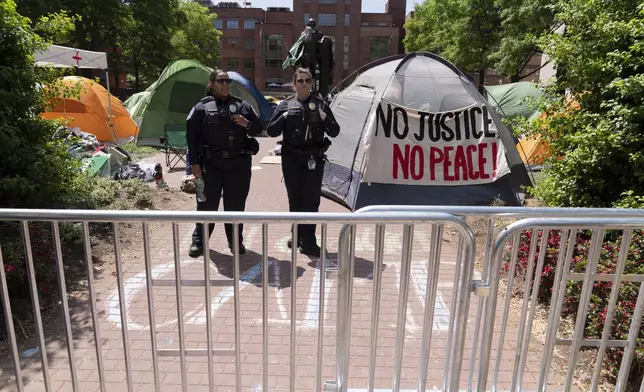 George Washington University police close the student encampment as students protest on the street during a pro-Palestinian protest over the Israel-Hamas war on Friday, April 26, 2024, in Washington. (AP Photo/Jose Luis Magana)