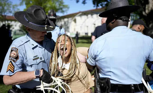 Georgia State Patrol officers detain a demonstrator on the campus of Emory Univeristy during a Israel Palestinian protest, Thursday, April 25, 2024, in Atlanta. (AP Photo/Mike Stewart)