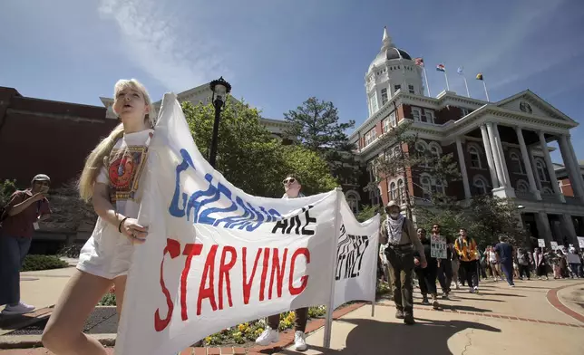 University of Missouri students parade a banner in front of Jesse Hall during a walkout and demonstration calling for a cease-fire in Gaza, Monday, April 29, 2024, in Columbia, Mo. The group made up of about 300 people met at Lowry Mall and walked toward Francis Quadrangle. (Brian W. Kratzer/Missourian via AP)