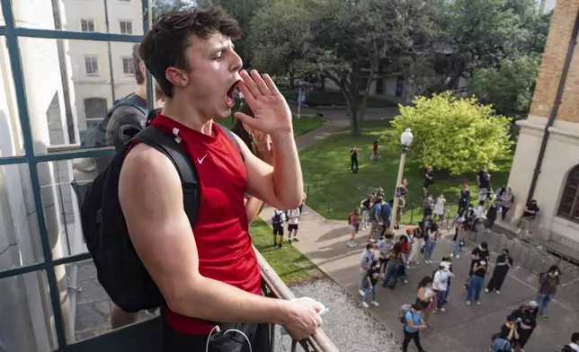Cameron Llewellyn chants from a balcony during a pro-Palestinian protest at the University of Texas, Wednesday, April 24, 2024, in Austin, Texas. (Mikala Compton/Austin American-Statesman via AP)