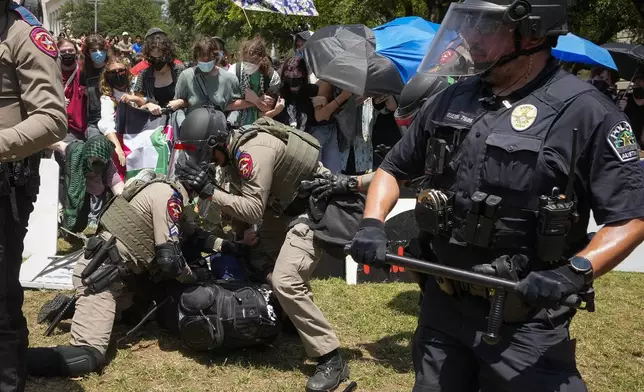 State troopers arrest a pro-Palestinian protester at the University of Texas in Austin, Texas, Monday, April 29, 2024. (Jay Janner/Austin American-Statesman via AP)