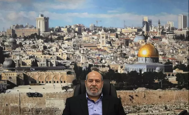 Khalil al-Hayya, a high-ranking official with the Palestinian militant group, who has represented it in negotiations for a ceasefire and hostage exchange deal, sits in front of a backdropped with a photograph of the old city of Jerusalem during an interview for The Associated Press, in Istanbul, Turkey, Wednesday, April 24, 2024.(AP Photo/Khalil Hamra)