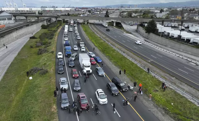 Protesters calling for a cease fire in Gaza shut down southbound traffic on Highway 880 in Oakland, Calif. on Monday, April 15, 2024. (Bronte Wittpenn/San Francisco Chronicle via AP)