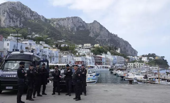 Italian Carabinieri paramilitary policemen gather at the Capri's harbour, Wednesday, April 17, 2024. Group of Seven foreign ministers are meeting on the Italian resort island of Capri, with soaring tensions in the Mideast and Russia's continuing war in Ukraine topping the agenda. The meeting runs April 17-19. (AP Photo/Gregorio Borgia)