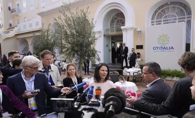 German Foreign Minister Annalena Baerbock talks to reporters during the G7 Foreign Ministers meeting on Capri Island, Italy, Thursday, April 18, 2024. (AP Photo/Gregorio Borgia)