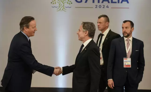 U.S. Secretary of State Antony Blinken, right, shakes hand with Britain's Foreign Secretary David Cameron as they attend an Indo-Pacific meeting on the sidelines of the G7 Foreign Ministers meeting on Capri Island, Italy, Friday, April 19, 2024. (AP Photo/Gregorio Borgia, Pool)