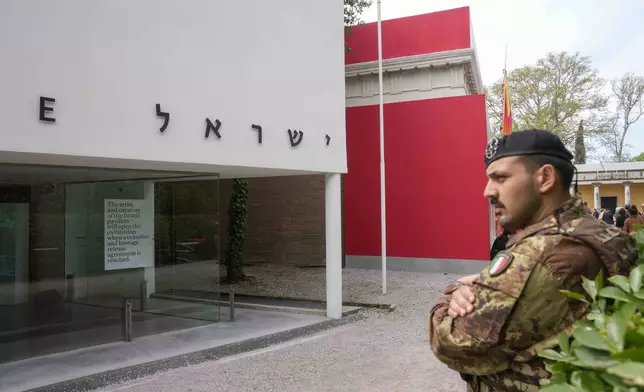 An Italian soldier stands in front of the closed Israeli national pavilion at the Biennale contemporary art fair in Venice, Italy, Tuesday, April 16, 2024. The artist and curators representing Israel at this year's Venice Biennale have announced Tuesday they won't open the Israeli pavilion until there is a cease-fire in Gaza and an agreement to release hostages taken Oct. 7.(AP Photo/Luca Bruno)