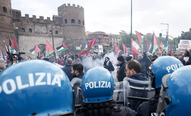 People hold Palestinians flags as they march during the solemn Liberation Day commemoration, in Rome, Thursday, April 25, 2024. Italy is marking its liberation from Nazi occupation and fascist rule amid a fresh media controversy over the legacy of Italian fascist complicity in the Holocaust and World War II-era crimes. Premier Giorgia Meloni, whose Brothers of Italy party traces its roots to the neo-fascist movement that emerged after the fall of dictator Benito Mussolini, joined the Italian president at the tomb of the unknown soldier in Rome. (Cecilia Fabiano/LaPresse via AP)
