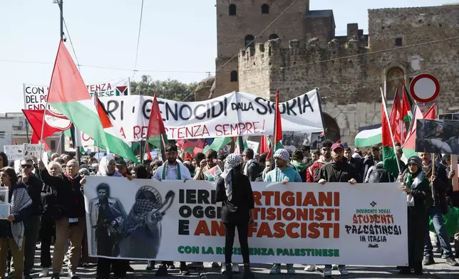 Palestinian supporters hold a banner reading "Yesterday partisans, today antiZionists and antifascists" as they march on the occasion of the Liberation Day commemoration marking Italy's liberation from Nazi occupation and fascist rule, in Rome, Thursday, April 25, 2024. (Cecilia Fabiano/LaPresse via AP)