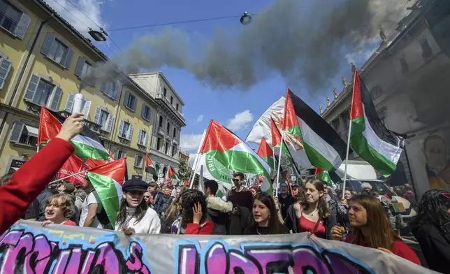 People holding Palestinians flags march on the occasion of Liberation Day in Milan, Italy, Thursday, April 25, 2024. Italy is marking its liberation from Nazi occupation and fascist rule amid a fresh media controversy over the legacy of Italian fascist complicity in the Holocaust and World War II-era crimes. (Claudio Furlan/LaPresse via AP)