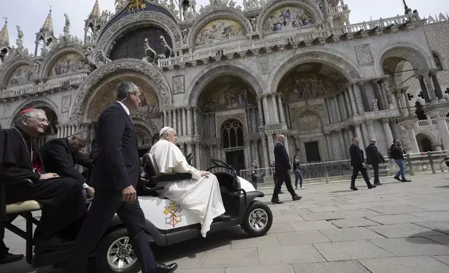 Pope Francis leaves St. Mark's Basilica in Venice, Italy, Sunday, April 28, 2024. The Pontiff arrived for his first-ever visit to the lagoon town including the Vatican pavilion at the 60th Biennal of Arts. (AP Photo/Alessandra Tarantino)