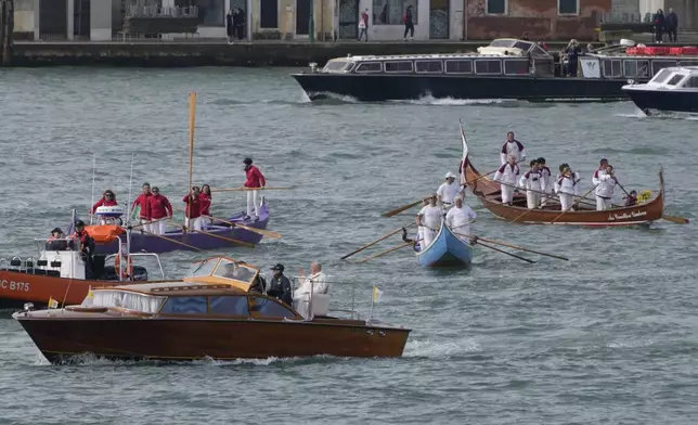 Pope Francis is greeted by Gondoliers upon his arrival in Venice, Italy, Sunday, April 28, 2024. The Pontiff arrived for his first-ever visit to the lagoon town including the Vatican pavilion at the 60th Biennal of Arts. (AP Photo/Alessandra Tarantino)