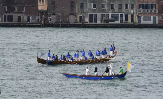 Gondoliers wait for arrival of Pope Francis in Venice, Sunday, April 28, 2024. The Pontiff arrived for his first-ever visit to the lagoon town including the Vatican pavilion at the 60th Biennal of Arts. (AP Photo/Alessandra Tarantino)