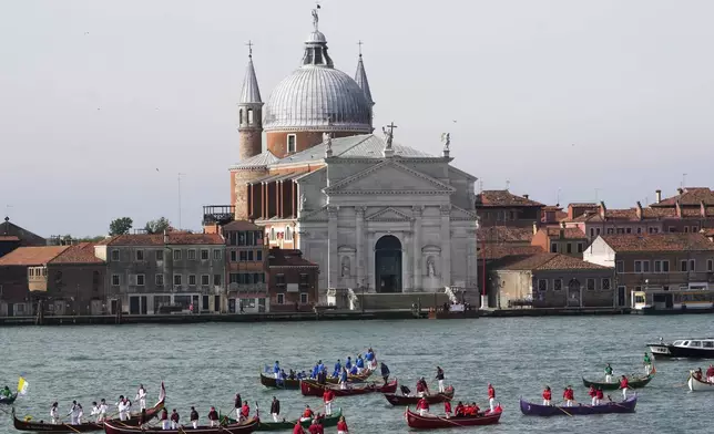 Gondoliers wait for the arrival of Pope Francis in front of the Santissimo Redentore church in Venice, Sunday, April 28, 2024. The Pontiff arrived for his first-ever visit to the lagoon town including the Vatican pavilion at the 60th Biennal of Arts. (AP Photo/Alessandra Tarantino)