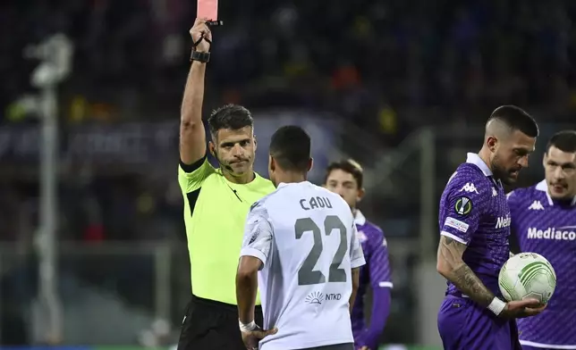 Referee Jesus Manzano shows a red card to Plzen's Cadu during the Europa Conference League quarter-final 2nd leg match between Fiorentina and Viktoria Plzen at the Artemio Franchi Stadium in Florence, Italy, Thursday, April 18, 2024. (Massimo Paolone/LaPresse via AP)