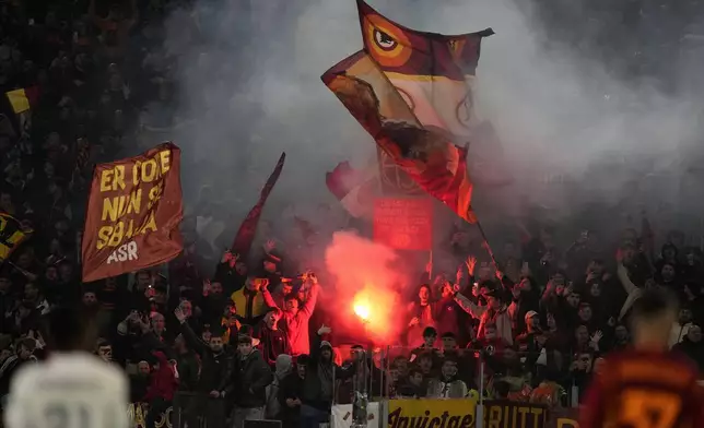 Fans of Roma cheer for their team during the Europa League quarterfinal second leg soccer match between Roma and AC Milan, at Rome's Olympic Stadium, Thursday, April 18, 2024. (AP Photo/Andrew Medichini)