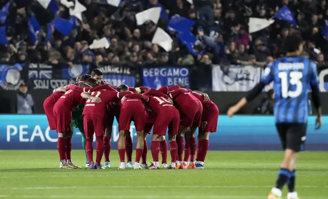Liverpool players gather together on the pitch before the start of the Europa League quarterfinal, second leg, soccer match between Atalanta and Liverpool at the Stadio di Bergamo, in Bergamo, Italy, Thursday, April 18, 2024. (AP Photo/Antonio Calanni)