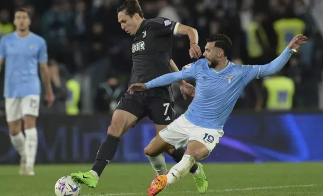 Juventus' Federico Chiesa, left, shields the ball from Lazio's Taty Castellanos during the Italian Cup semi-final soccer match between Lazio and Juventus at Rome's Olympic Stadium, Italy, Tuesday, April 23, 2024. (Alfredo Falcone/LaPresse via AP)