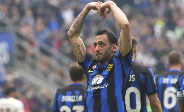 Inter Milan's Hakan Calhanoglu celebrates after scoring his side's second goal from a penalty kick during a Serie A soccer match between Inter Milan and Torino at the San Siro stadium in Milan, Italy, Sunday, April 28, 2024. (AP Photo/Luca Bruno)
