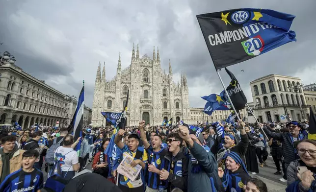 Inter Milan fans celebrate as they wait for the team to arrive in an open-air bus to the Duomo cathedral to celebrate the Nerazzurri's 20th Italian league title, in Milan, Italy, Sunday, April 28, 2024. (Claudio Furlan/LaPresse via AP)