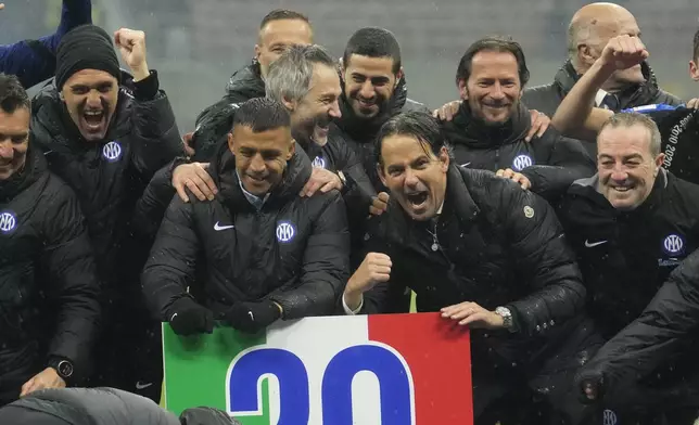 Inter Milan's head coach Simone Inzaghi, center, right, celebrates with his teammate at the end of the Serie A soccer match between AC Milan and Inter Milan at the San Siro stadium in Milan, Italy, Monday, April 22, 2024. (AP Photo/Luca Bruno)