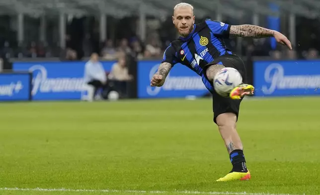 Inter Milan's Federico Dimarco has a shot during the Italian Serie A soccer match between Inter Milan and Cagliari at the San Siro stadium in Milan, Italy, Sunday, April 14, 2024. (AP Photo/Antonio Calanni)