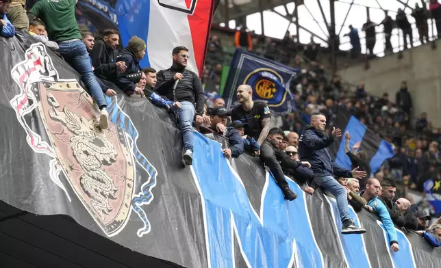 Inter fans watch the Serie A soccer match between Inter Milan and Torino at the San Siro stadium in Milan, Italy, Sunday, April 28, 2024. (AP Photo/Luca Bruno)