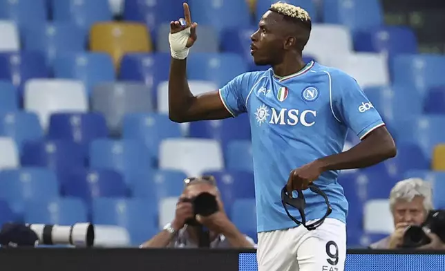 Napoli's Victor Osimhen celebrates scoring on a penalty his side's second goal during a Serie A soccer match between Napoli and Roma at the Diego Armando Maradona Stadium in Naples, Italy, Sunday, April 28, 2024. (Alessandro Garofalo/LaPresse via AP)