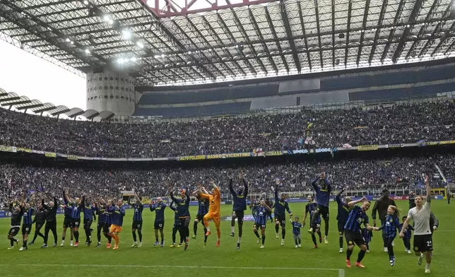 Inter Milan players celebrate in front of fans at the end of a Serie A soccer match between Inter Milan and Torino at the San Siro stadium in Milan, Italy, Sunday, April 28, 2024. Inter Milan had already clinched the Italian Serie A league title the week before. (AP Photo/Luca Bruno)