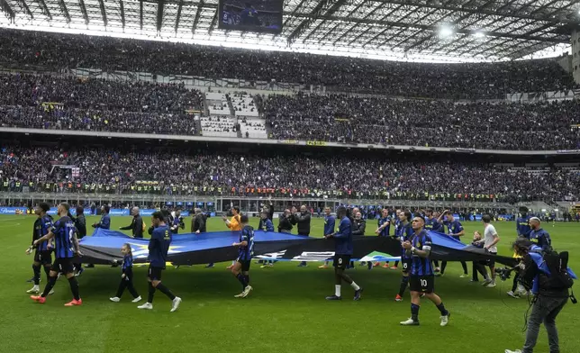 Inter Milan players celebrate in front of fans at the end of a Serie A soccer match between Inter Milan and Torino at the San Siro stadium in Milan, Italy, Sunday, April 28, 2024. Inter Milan had already clinched the Italian Serie A league title the week before. (AP Photo/Luca Bruno)