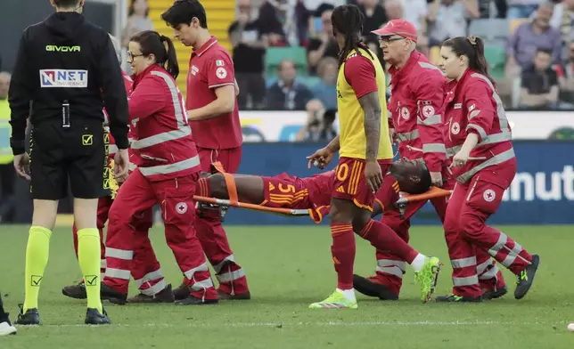 Roma's Evan Ndicka is carried off the pitch on a stretcher during the Serie A soccer match between Udinese and Roma at the Bluenergy Stadium in Udine, Italy, Sunday, April 14, 2024. (Andrea Bressanutti/LaPresse via AP)