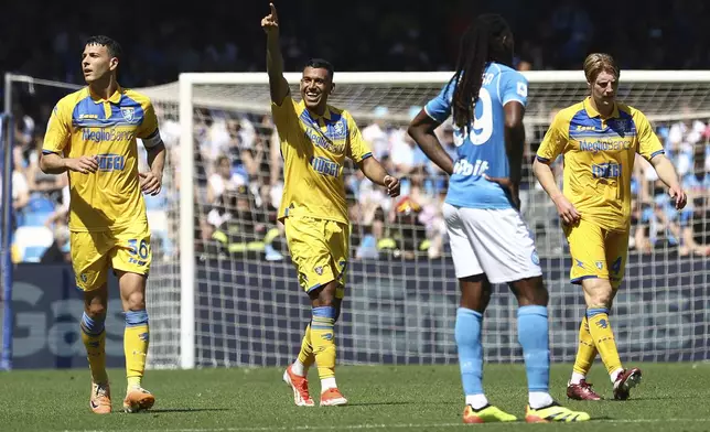 Frosinone's Walid Cheddira, center, celebrates after scoring his side's second goal during a Serie A soccer match between Napoli and Frosinone at the Diego Armando Maradona Stadium in Naples, Italy, Sunday, April 14, 2024. (Alessandro Garofalo/LaPresse via AP)