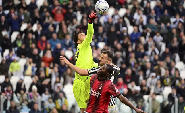 AC Milan's goalkeeper Marco Sportiello, left, punches away the ball as Juventus' Federico Gatti, center, and AC Milan's Yunus Musah vie for the ball during a Serie A soccer match between Juventus and Milan at the Allianz Stadium in Turin, Italy, Saturday, April 27, 2024. (Marco Alpozzi/LaPresse via AP)