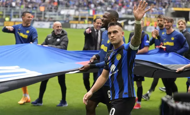 Inter Milan's Lautaro Martinez waves with players celebrating in front of fans at the end of a Serie A soccer match between Inter Milan and Torino at the San Siro stadium in Milan, Italy, Sunday, April 28, 2024. Inter Milan had already clinched the Italian Serie A league title the week before. (AP Photo/Luca Bruno)