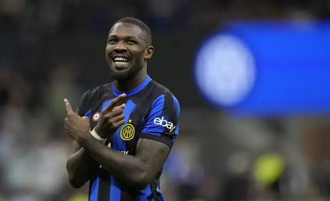 Inter Milan's Marcus Thuram celebrates after scoring his side's opening goal during the Italian Serie A soccer match between Inter Milan and Cagliari at the San Siro stadium in Milan, Italy, Sunday, April 14, 2024. (AP Photo/Antonio Calanni)