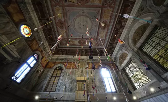 An installation by artist Sonia Gomes is displayed inside the church Santa Maria Maddalena Convertita at the women's prison of he Giudecca island during the 60th Biennale of Arts exhibition in Venice, Italy, Wednesday, April 17, 2024. A pair of nude feet dirty, wounded and vulnerable are painted on the façade of the Venice women's prison chapel, the work of Italian artist Maurizio Cattelan and part of the Vatican's pavilion at the Venice Biennale in an innovative collaboration between inmates and artists. (AP Photo/Luca Bruno)