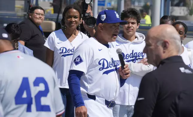 Los Angeles Dodgers manager Dave Roberts, center, introduces Ayo Robinson, rear left, the granddaughter of baseball legend Jackie Robinson, as Dodgers and Washington Nationals team members join in a celebration for Jackie Robinson Day before a baseball game at Dodgers Stadium in Los Angeles on Monday, April 15, 2024. (AP Photo/Damian Dovarganes)