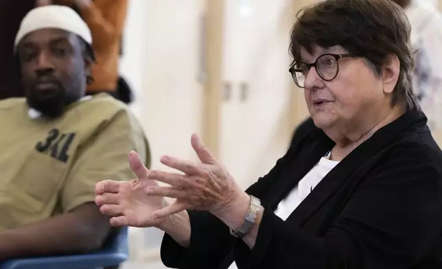 Sister Helen Prejean, right, talks during a book club as detainee listens at Department Of Corrections Division 11 in Chicago, Monday, April 22, 2024. DePaul students and detainees are currently reading Dead Man Walking and the author, anti death penalty advocate, Sister Helen Prejean attended to lead a discussion. (AP Photo/Nam Y. Huh)