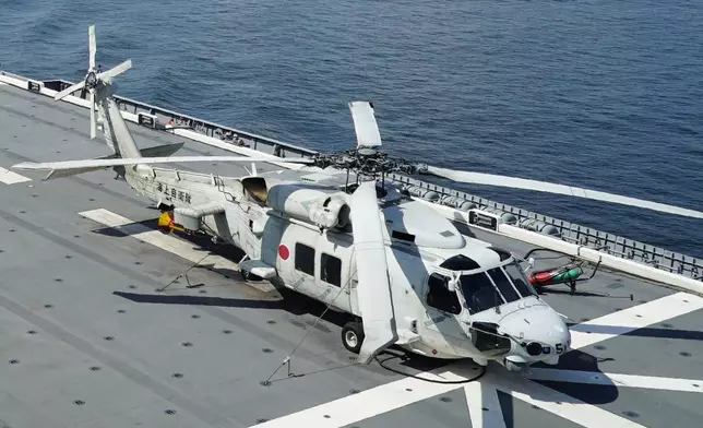 FILE - An SH-60K anti-submarine helicopter sits on the flight deck of Japan's Maritime Self Defense Force (JMSDF) helicopter carrier JS Izumo (DDH-183) off the coast of Brunei on June 26, 2019. Late Saturday, April 20, 2024, contact was lost with two Japanese navy SH-60K choppers carrying eight crewmembers, believed to have crashed in the Pacific Ocean south of Tokyo during a night-time training exercise, and rescuers were searching for the missing, Japan’s defense minister said. (AP Photo/Emily Wang, File)