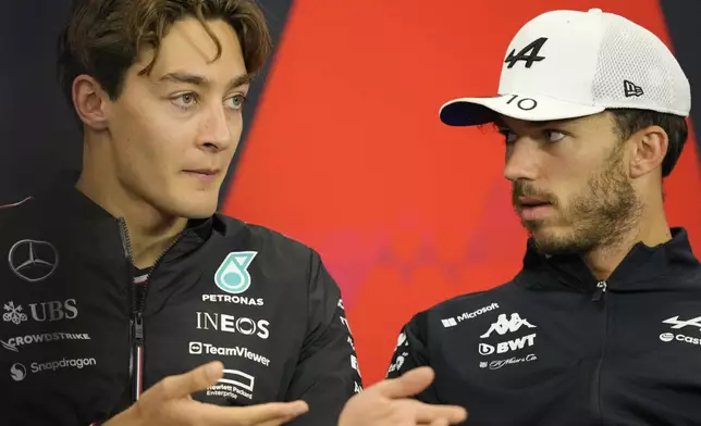 Mercedes driver George Russell of Britain, left, talks with Alpine driver Pierre Gasly of France during a news conference at the Suzuka Circuit in Suzuka, central Japan, Thursday, April 4, 2024, ahead of Sunday's Japanese Formula One Grand Prix. (AP Photo/Hiro Komae)