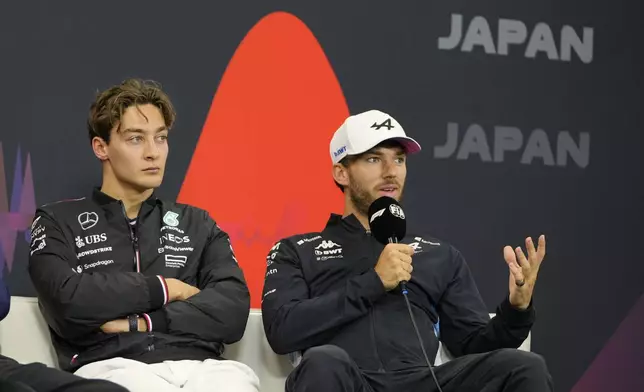 Alpine driver Pierre Gasly of France speaks as Mercedes driver George Russell of Britain listens during a news conference at the Suzuka Circuit in Suzuka, central Japan, Thursday, April 4, 2024, ahead of Sunday's Japanese Formula One Grand Prix. (AP Photo/Hiro Komae)