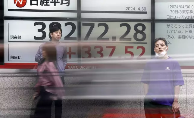 People stand in front of an electronic stock board showing Japan's Nikkei 225 index at a securities firm Tuesday, April 30, 2024, in Tokyo. Asian shares mostly rose Tuesday, as investors kept their eyes on potentially market-moving reports expected later this week.(AP Photo/Eugene Hoshiko)