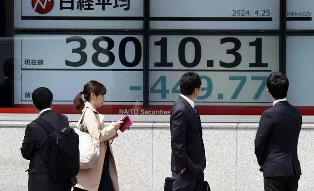 People look at an electronic stock board showing Japan's Nikkei 225 index at a securities firm Thursday, April 25, 2024, in Tokyo. (AP Photo/Eugene Hoshiko)