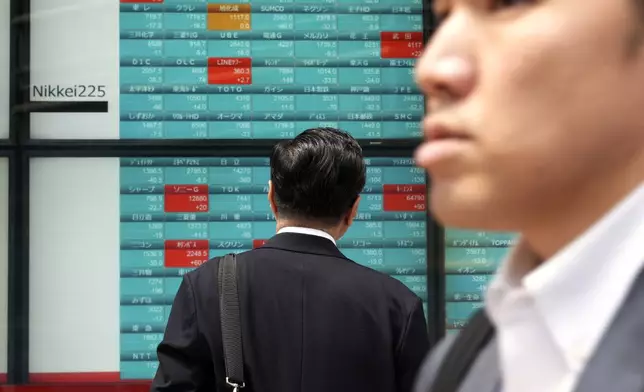 A person looks at an electronic stock board showing Japan's Nikkei 225 index at a securities firm Tuesday, April 16, 2024, in Tokyo. (AP Photo/Eugene Hoshiko)