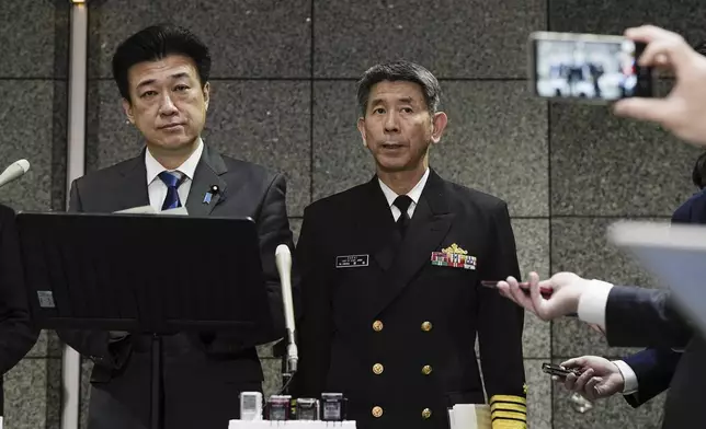Japanese Defense Minister Minoru Kihara, left, and Japanese navy chief of staff Ryo Sakai, right, attend a press conference at Defense Ministry in Tokyo Monday, April 22, 2024. Initial analysis of flight data recorders recovered from the waters in the Pacific near the crash site of the two Japanese navy helicopters showed no sign that mechanical problems in the aircraft caused the accident, Japan’s defense minister said Monday, as he indicated human error. (Kyodo News via AP)