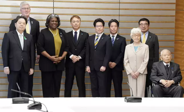 U.S. Ambassador to United Nations Linda Thomas-Greenfield, third from left, poses for a photo with Japan's Chief Cabinet Secretary Yoshimasa Hayashi, left, and the families of abduction victims by North Korea on Thursday, April 18, 2024, at prime minister's office in Tokyo. (AP Photo/Eugene Hoshiko, Pool)