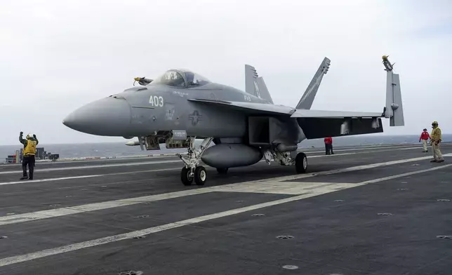A F-18E parks on the flight deck of a USS Theodore Roosevelt aircraft carrier on Thursday, April 11, 2024 during a three-day joint naval exercise by the U.S., Japanese and South Korea at the East China Sea amid tension from China and North Korea. (AP Photo/Mari Yamaguchi)