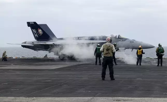 A F-18E fighter jet prepares to take off from USS Theodore Roosevelt aircraft carrier on Thursday April 11, 2024, during a three-day joint naval exercise by the U.S., Japanese and South Korea at the East China Sea amid tension from China and North Korea. (AP Photo/Mari Yamaguchi)